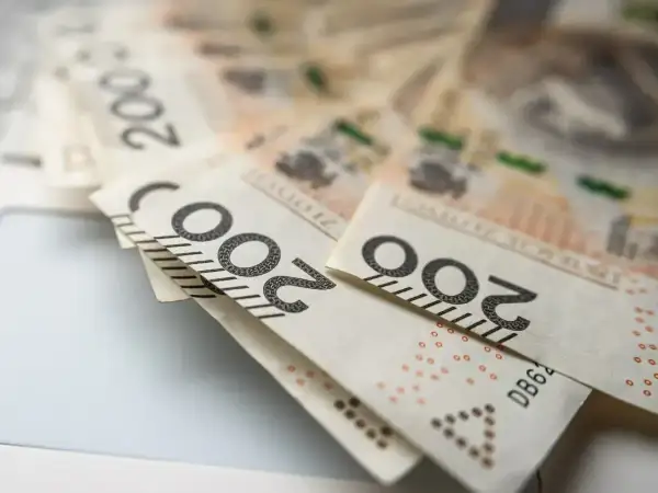 Polskie banknoty 200 zł leżące na jasnym tle.